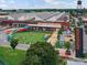 Sprawling commercial property featuring a large green lawn, colorful play structures, and unique architectural details at 2017 Brewton Dr, Charlotte, NC 28206