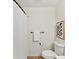Clean bathroom with a white toilet, wall art, and a shower with a white curtain at 2017 Brewton Dr, Charlotte, NC 28206