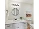 Bathroom featuring a vanity with white countertops, a round mirror, and modern lighting fixtures at 2017 Brewton Dr, Charlotte, NC 28206