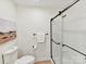 Bathroom featuring a glass-enclosed shower, toilet, and towel rack at 2017 Brewton Dr, Charlotte, NC 28206