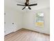 A light-filled bedroom with neutral walls, light vinyl floors, and a modern ceiling fan at 2017 Brewton Dr, Charlotte, NC 28206