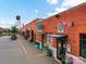 Charming brick commercial spaces offer fresh produce with vibrant signage and sidewalk planters at 2017 Brewton Dr, Charlotte, NC 28206