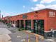 Brick commercial building with glass storefronts and visible unit number and vintage wall sconces at 2017 Brewton Dr, Charlotte, NC 28206