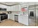 Updated kitchen featuring stainless steel appliances, modern hardware, and white cabinets at 2017 Brewton Dr, Charlotte, NC 28206