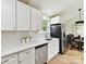 Modern kitchen featuring stainless steel appliances, white cabinets, and a bright, clean design with wood-style floors at 2017 Brewton Dr, Charlotte, NC 28206