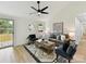 Bright living room with a modern ceiling fan, neutral decor, and ample natural light at 2017 Brewton Dr, Charlotte, NC 28206