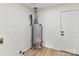 Utility area with a water heater, clean walls, vinyl flooring, and a door at 2017 Brewton Dr, Charlotte, NC 28206