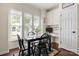 Charming dining area with bright windows, dark wood floors, built in cabinets, and a desk at 2066 Vermount Way, Indian Land, SC 29707