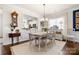 Inviting dining room with wood floors, wainscoting, neutral decor, and a view into the kitchen at 2066 Vermount Way, Indian Land, SC 29707