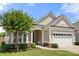 Well-maintained single-story home featuring manicured landscaping, an attached two car garage, and welcoming entryway at 2066 Vermount Way, Indian Land, SC 29707