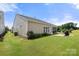 Side view of home with lush green lawn, patio, grill and screened in porch at 2066 Vermount Way, Indian Land, SC 29707