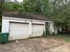Detached two-car garage with weathered doors and climbing ivy, adding rustic charm at 2096 S Point Rd, Belmont, NC 28012