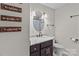 Cozy bathroom featuring a stylish vanity, oval mirror and rustic wall decor for a relaxing spa-like atmosphere at 2146 Marwood Ln, Albemarle, NC 28001