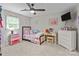 Bright bedroom with colorful decor, ceiling fan, and carpeted floor, creating a playful and inviting space at 2146 Marwood Ln, Albemarle, NC 28001