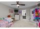 This bedroom features a ceiling fan, TV, and an open closet with generous storage and organization options at 2146 Marwood Ln, Albemarle, NC 28001