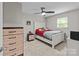 Comfortable bedroom features a ceiling fan, carpeted floor, and ample closet space for organized storage at 2146 Marwood Ln, Albemarle, NC 28001
