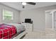 Bedroom featuring a ceiling fan, carpeted floor, and a view of an adjacent closet for easy access to wardrobe at 2146 Marwood Ln, Albemarle, NC 28001