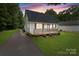 Charming home featuring a well-kept lawn, a driveway with basketball hoop, and a cozy front porch at 2146 Marwood Ln, Albemarle, NC 28001