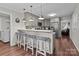 Modern kitchen with stainless appliances, bar seating, and hardwood floors at 2146 Marwood Ln, Albemarle, NC 28001