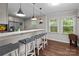 Eat-in kitchen bar with pendant lighting, stainless steel appliances, and views to the back yard at 2146 Marwood Ln, Albemarle, NC 28001