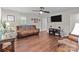 Inviting living room featuring hardwood floors and a ceiling fan, ideal for relaxation at 2146 Marwood Ln, Albemarle, NC 28001