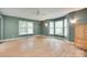 Large primary bedroom boasts hardwood floors, a ceiling fan, and large windows offering ample natural light at 257 Amity Dr, York, SC 29745