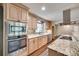 Bright kitchen featuring stainless steel appliances, granite countertops, and natural wood cabinets at 257 Amity Dr, York, SC 29745