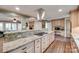 Well-lit kitchen featuring granite countertops, stainless steel vent hood, and ample cabinet space at 257 Amity Dr, York, SC 29745