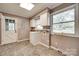Functional laundry room features tile flooring, white cabinetry, and a utility sink at 257 Amity Dr, York, SC 29745