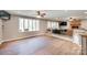 Spacious living room with large windows, wood floors, and a cozy brick fireplace at 257 Amity Dr, York, SC 29745