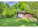 Backyard featuring a storage shed with white doors, offering practical solutions for outdoor tools and equipment at 257 Amity Dr, York, SC 29745