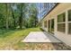 View of a backyard with a concrete patio and sliding glass doors leading into the home at 2705 Enon Church Rd, Salisbury, NC 28147