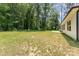 Side view of a well-maintained backyard with a grassy lawn and exterior view of the house at 2705 Enon Church Rd, Salisbury, NC 28147