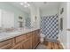 Beautiful bathroom featuring double sinks, granite countertops, and modern blue patterned shower curtain at 2705 Enon Church Rd, Salisbury, NC 28147