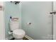 Cozy half-bathroom with light blue walls, toilet and minimalist decorations at 2705 Enon Church Rd, Salisbury, NC 28147