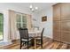 Cozy dining area featuring wood floors, a modern chandelier, and a view of the outdoors at 2705 Enon Church Rd, Salisbury, NC 28147