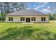 Back exterior view of the house with a grassy lawn, a concrete patio, and a neutral siding at 2705 Enon Church Rd, Salisbury, NC 28147