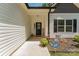 Inviting front porch features a Welcome sign, potted plants and a security system sign at 2705 Enon Church Rd, Salisbury, NC 28147