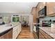 Modern kitchen with an island, stainless steel appliances, wood floors, and an adjoining dining area at 2705 Enon Church Rd, Salisbury, NC 28147