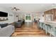 Open-concept living space with wood floors, ceiling fan, and access to the kitchen and dining area at 2705 Enon Church Rd, Salisbury, NC 28147