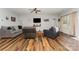 Cozy living room with wood flooring, comfortable seating and a mounted TV above a wooden shelf at 2705 Enon Church Rd, Salisbury, NC 28147