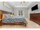 Spacious main bedroom featuring a tray ceiling, large window, TV, and wooden furniture at 2705 Enon Church Rd, Salisbury, NC 28147
