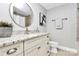 Bathroom featuring a granite countertop, updated fixtures, and a neutral color scheme at 300 W 5Th St # 003, Charlotte, NC 28202