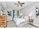 Serene bedroom with hardwood floors, designer rug, and ceiling fan at 300 W 5Th St # 003, Charlotte, NC 28202
