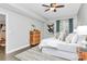 Bright bedroom featuring a ceiling fan, wood dresser, modern art, and a large window at 300 W 5Th St # 003, Charlotte, NC 28202
