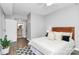 Bedroom featuring a view of the bathroom, wood floors, and decorative pillows at 300 W 5Th St # 003, Charlotte, NC 28202