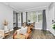 Bright dining area with large windows, wood floors, and comfortable seating at 300 W 5Th St # 003, Charlotte, NC 28202