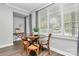 Bright dining area with large windows, wood floors, and comfortable seating at 300 W 5Th St # 003, Charlotte, NC 28202
