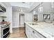 Bright kitchen featuring bar seating with pendant lights and a stainless steel dishwasher at 300 W 5Th St # 003, Charlotte, NC 28202