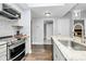 Well-equipped kitchen with stainless appliances, bright countertops, and recessed lighting at 300 W 5Th St # 003, Charlotte, NC 28202